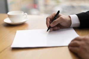 close-up-business-man-taking-notes